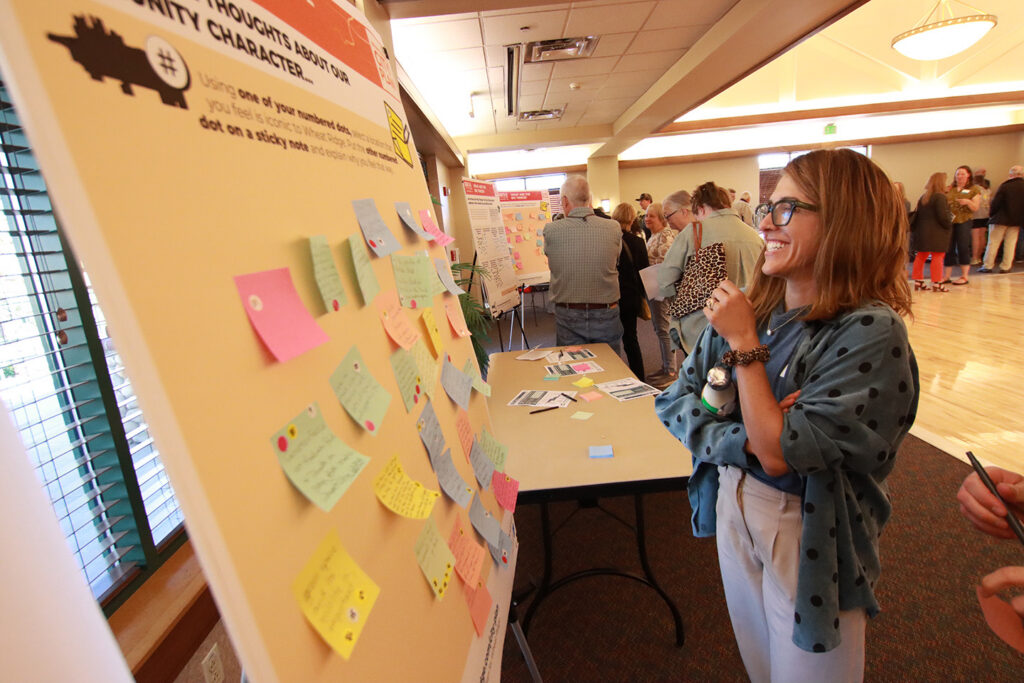 Person looking at a poster at the CZB Wheat Ridge Colorado Community Meeting
